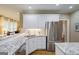 Bright kitchen with stainless steel appliances, granite countertops, and hardwood floors at 1621 White Oak Cv, Loganville, GA 30052