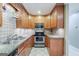 Charming kitchen featuring granite countertops, stainless steel appliances, and wood cabinets at 1621 White Oak Cv, Loganville, GA 30052