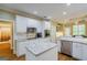 Bright kitchen featuring white cabinets, stainless steel appliances, and granite countertops at 1621 White Oak Cv, Loganville, GA 30052