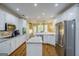 Spacious kitchen with white cabinets, granite countertops, stainless steel appliances, and hardwood floors at 1621 White Oak Cv, Loganville, GA 30052