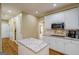 Well-lit kitchen with a white island, cabinets, stainless steel appliances, and hardwood floors at 1621 White Oak Cv, Loganville, GA 30052