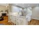 Open kitchen with a sink, granite countertops, a refrigerator, and hardwood floors at 1621 White Oak Cv, Loganville, GA 30052