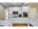 Bright kitchen with white cabinets, stainless steel appliances, granite countertops, and hardwood floors at 1621 White Oak Cv, Loganville, GA 30052