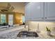 Close-up of a modern kitchen sink with granite countertops and white subway tile backsplash at 1621 White Oak Cv, Loganville, GA 30052