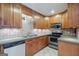 Well-maintained kitchen featuring wooden cabinets, stainless steel appliances, and tiled backsplash accents at 1621 White Oak Cv, Loganville, GA 30052