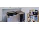 Well-equipped laundry room featuring side-by-side washer and dryer, and ample storage shelving for convenience at 1621 White Oak Cv, Loganville, GA 30052