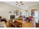 Bright living room featuring hardwood floors, a brick fireplace, and a large window at 1621 White Oak Cv, Loganville, GA 30052