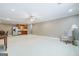 Spacious living area showcasing kitchen, eating area, and chair with lamp at 1621 White Oak Cv, Loganville, GA 30052