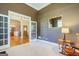 Versatile room with neutral carpet, open doorway, and rocking chair at 1621 White Oak Cv, Loganville, GA 30052