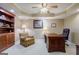 Spacious office with a large wooden desk, seating area, and a tray ceiling with recessed lighting at 1621 White Oak Cv, Loganville, GA 30052