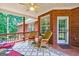 Inviting covered patio with brick accents and comfortable wicker seating, perfect for relaxing at 1621 White Oak Cv, Loganville, GA 30052