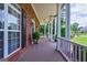 Spacious front porch with white columns, ideal for relaxing and enjoying the outdoors at 1621 White Oak Cv, Loganville, GA 30052
