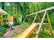 Backyard with a swing set, slide, basketball hoop, and storage shed at 2257 Chestnut Log Loop, Lithia Springs, GA 30122