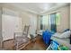 Cozy bedroom with hardwood floors, featuring a rocking chair, bed, and natural light at 2257 Chestnut Log Loop, Lithia Springs, GA 30122