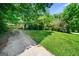 Exterior view of a home with a covered driveway and spacious front yard, offering lots of green space at 2257 Chestnut Log Loop, Lithia Springs, GA 30122