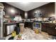 View of the kitchen featuring dark cabinets and stainless steel appliances, needs TLC at 2257 Chestnut Log Loop, Lithia Springs, GA 30122