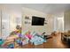 A spacious living room with hardwood floors and a neutral color scheme, needs TLC at 2257 Chestnut Log Loop, Lithia Springs, GA 30122