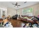 A look at a living room with hardwood floors, a large window, and a ceiling fan at 2257 Chestnut Log Loop, Lithia Springs, GA 30122