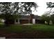 View of the home's brick facade with a brick chimney, a patio and a large fenced-in backyard at 3857 Pointers Sw Way, Conyers, GA 30094