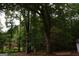 Backyard view with lots of trees, small outbuilding, and natural setting at 3857 Pointers Sw Way, Conyers, GA 30094