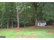 Property has a private, tree-filled backyard and outbuilding at 3857 Pointers Sw Way, Conyers, GA 30094