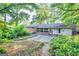 View of the backyard featuring a patio, lush green garden, and the rear of the home at 1283 Bramble Ne Rd, Atlanta, GA 30329
