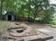 Private backyard featuring a storage shed, brick patio, and a tranquil pond, creating a peaceful outdoor sanctuary at 1283 Bramble Ne Rd, Atlanta, GA 30329