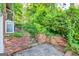 Backyard features a brick wall and lush foliage at 1283 Bramble Ne Rd, Atlanta, GA 30329
