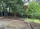 Lush backyard featuring mature trees, a shed, and a brick-lined garden plot, creating a serene outdoor space at 1283 Bramble Ne Rd, Atlanta, GA 30329