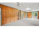 Spacious basement featuring wood paneling, neutral carpet, and sliding door access to exterior at 1283 Bramble Ne Rd, Atlanta, GA 30329