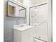 This bathroom has gray tiling, a mirror, and a glass shower at 1283 Bramble Ne Rd, Atlanta, GA 30329