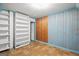 Bedroom features blue walls, tile floors, shelves, and a closet at 1283 Bramble Ne Rd, Atlanta, GA 30329