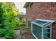 Exterior view of home with a brick wall and a greenhouse at 1283 Bramble Ne Rd, Atlanta, GA 30329