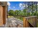 Wide wooden deck showcasing a wooden safety rail, and a view of the backyard trees at 315 Burke Cir, Mcdonough, GA 30253