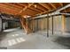 Unfinished basement with exposed wooden beams and stairs at 315 Burke Cir, Mcdonough, GA 30253