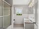 Bathroom with white tiles, a shower with a glass door, and a decorative chandelier at 315 Burke Cir, Mcdonough, GA 30253
