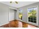 Sunlit bedroom showcases hardwood floors, closet, and large windows overlooking the yard at 315 Burke Cir, Mcdonough, GA 30253