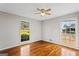 Sunlit bedroom with gleaming hardwood floors and ceiling fan at 315 Burke Cir, Mcdonough, GA 30253