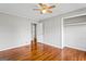 Comfortable bedroom features beautiful hardwood floors, a ceiling fan, and closet space at 315 Burke Cir, Mcdonough, GA 30253