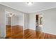 Open dining room with hardwood floors, with a view to the living room and kitchen at 315 Burke Cir, Mcdonough, GA 30253