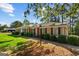 Brick ranch home with manicured shrubs, black shutters and a welcoming lamp post at 315 Burke Cir, Mcdonough, GA 30253