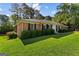 Beautiful brick home with green lawn, manicured shrubs, and a classic architectural style at 315 Burke Cir, Mcdonough, GA 30253