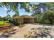 Brick home with a porte cochere, well-maintained lawn, trimmed shrubs, and driveway at 315 Burke Cir, Mcdonough, GA 30253