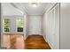 Bright foyer featuring hardwood floors, a closet, and views into the living room at 315 Burke Cir, Mcdonough, GA 30253
