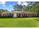 Classic brick ranch home with black shutters and a beautifully maintained front lawn at 315 Burke Cir, Mcdonough, GA 30253
