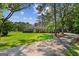 Charming brick home with a well-manicured lawn and a long driveway, framed by mature trees at 315 Burke Cir, Mcdonough, GA 30253