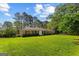 Traditional brick home with black shutters and a lush front yard in a serene, wooded setting at 315 Burke Cir, Mcdonough, GA 30253
