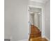 A bright hallway with hardwood floors and white trim, offering access to various rooms at 315 Burke Cir, Mcdonough, GA 30253