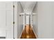 Hallway featuring hardwood floors, neutral walls, and multiple doorways for easy access at 315 Burke Cir, Mcdonough, GA 30253