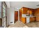 A kitchen with wooden cabinets and a window offering natural light and neutral colored countertop and tile flooring at 315 Burke Cir, Mcdonough, GA 30253